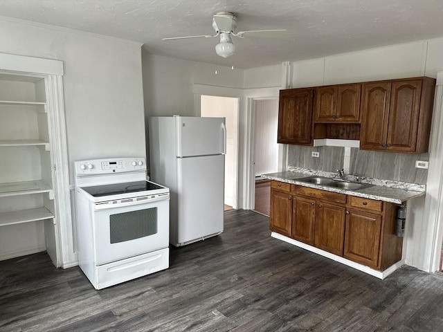 kitchen with dark hardwood / wood-style flooring, sink, white appliances, and ceiling fan