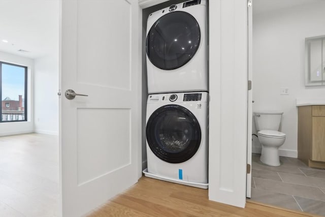 256 Dorchester St Unit 408, Boston, MA 02127 - laundry room with stacked washing machine and dryer and baseboards