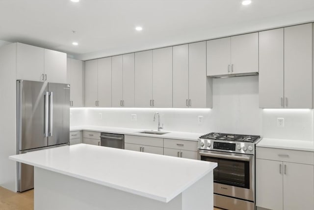 256 Dorchester St Unit 408, Boston, MA 02127 - kitchen with appliances with stainless steel finishes, a sink, light countertops, recessed lighting, and a center island