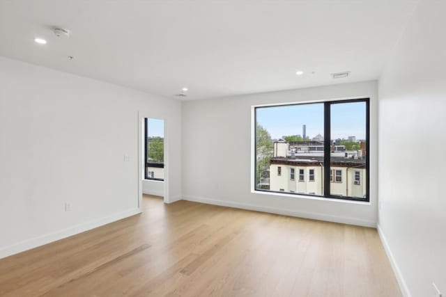 256 Dorchester St Unit 408, Boston, MA 02127 - empty room featuring light wood-type flooring, baseboards, recessed lighting, and a smoke detector