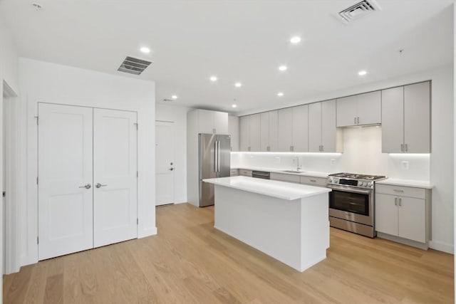 256 Dorchester St Unit 408, Boston, MA 02127 - kitchen with stainless steel appliances, a sink, light wood-type flooring, light countertops, and recessed lighting