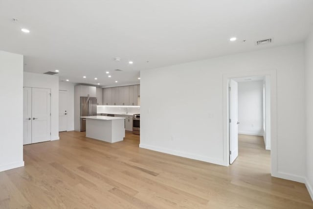 256 Dorchester St Unit 408, Boston, MA 02127 - unfurnished living room with light wood-style flooring, recessed lighting, and baseboards
