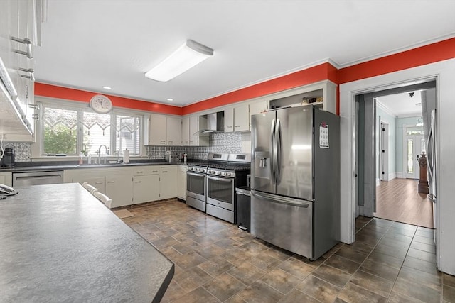 41 Edwards St, Southbridge, MA 01550 - kitchen featuring appliances with stainless steel finishes, wall chimney exhaust hood, crown molding, decorative backsplash, and dark countertops