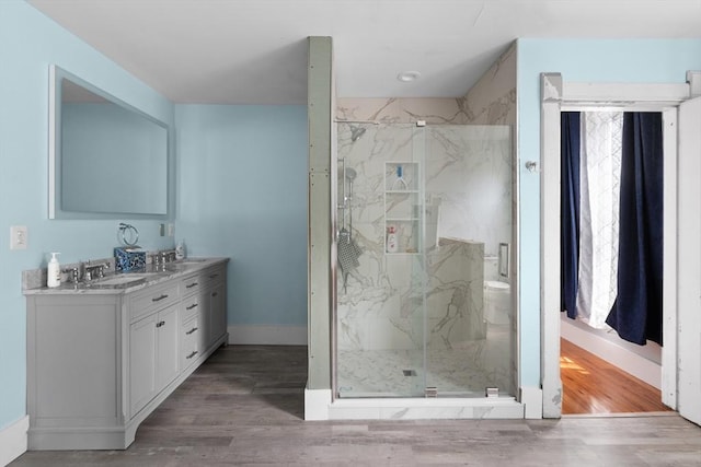 41 Edwards St, Southbridge, MA 01550 - bathroom featuring a marble finish shower, double vanity, and wood finished floors
