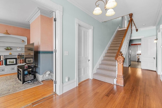 41 Edwards St, Southbridge, MA 01550 - staircase featuring a chandelier, wood finished floors, and ornamental molding
