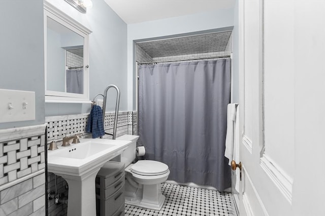 41 Edwards St, Southbridge, MA 01550 - bathroom featuring tile walls, a shower with shower curtain, tile patterned floors, and wainscoting