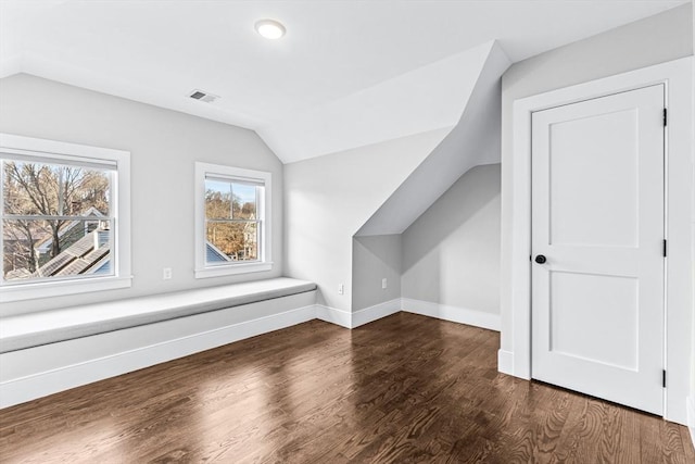 additional living space featuring vaulted ceiling and dark hardwood / wood-style floors