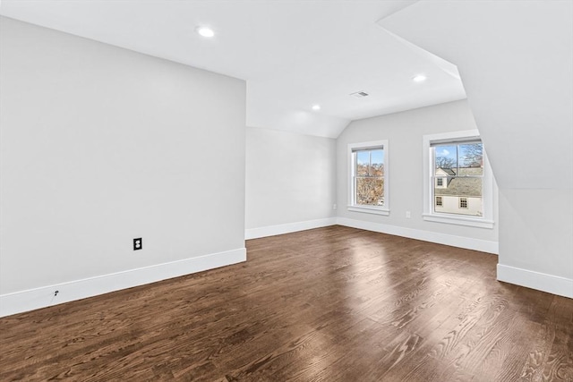 unfurnished living room with lofted ceiling and dark hardwood / wood-style floors