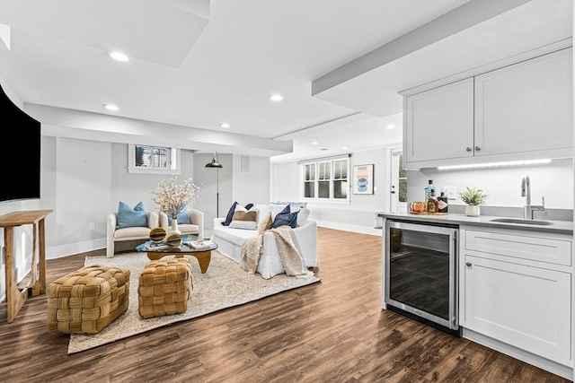 interior space featuring sink, wine cooler, dark hardwood / wood-style flooring, and white cabinetry