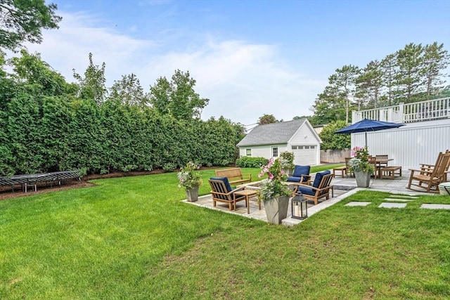 view of yard featuring a patio area, a trampoline, a garage, and an outdoor structure