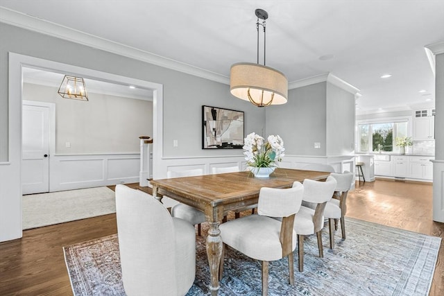 dining room with ornamental molding and dark hardwood / wood-style floors