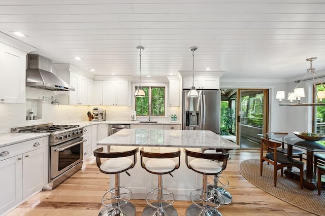 15 Youngs Rd, Gloucester, MA 01930 - kitchen featuring stainless steel appliances, wall chimney exhaust hood, a sink, plenty of natural light, and recessed lighting