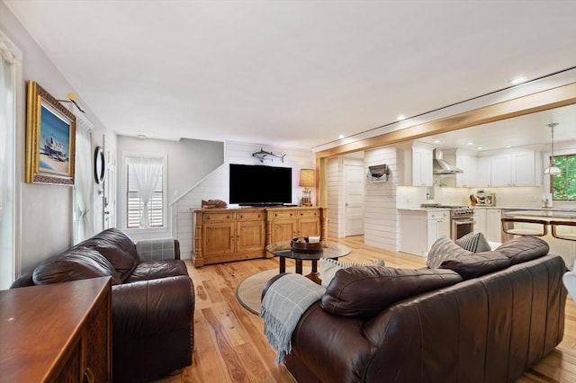 15 Youngs Rd, Gloucester, MA 01930 - living room with light wood-style floors and wood walls