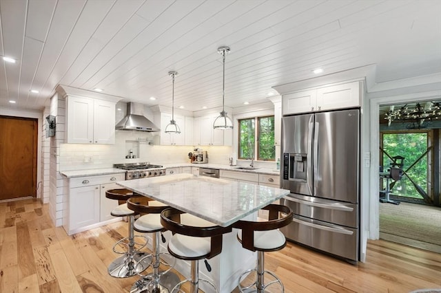 15 Youngs Rd, Gloucester, MA 01930 - kitchen with appliances with stainless steel finishes, wall chimney exhaust hood, a sink, light wood finished floors, and recessed lighting