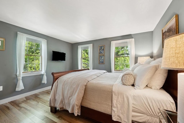 15 Youngs Rd, Gloucester, MA 01930 - bedroom with multiple windows, wood finished floors, and baseboards
