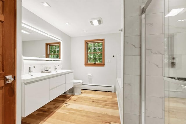 15 Youngs Rd, Gloucester, MA 01930 - bathroom with a baseboard heating unit, double vanity, wood finished floors, an enclosed shower, and toilet