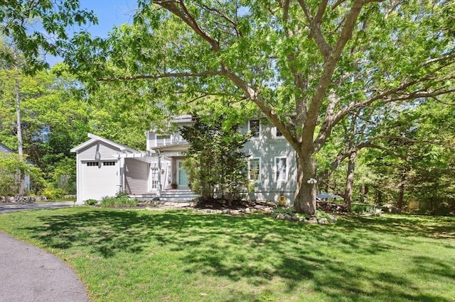 15 Youngs Rd, Gloucester, MA 01930 - view of property hidden behind natural elements with a garage, a front yard, and asphalt driveway