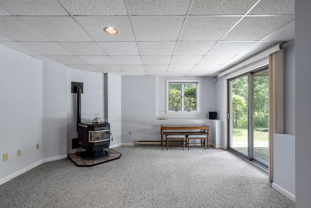 27 Quarryridge Ln Unit 27, Rockport, MA 01966 - living area with carpet floors, a drop ceiling, and a wood stove
