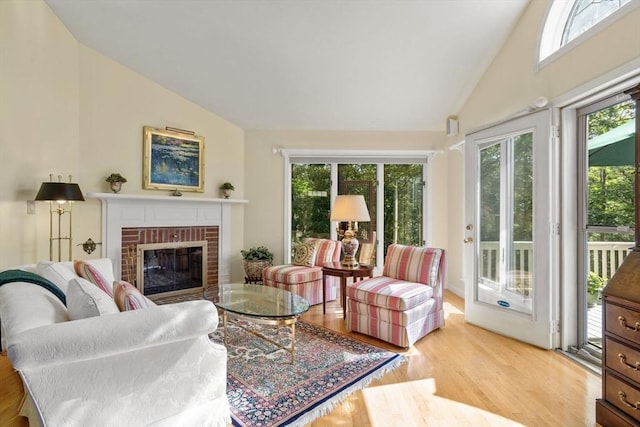 27 Quarryridge Ln Unit 27, Rockport, MA 01966 - living area with wood finished floors, a brick fireplace, and high vaulted ceiling