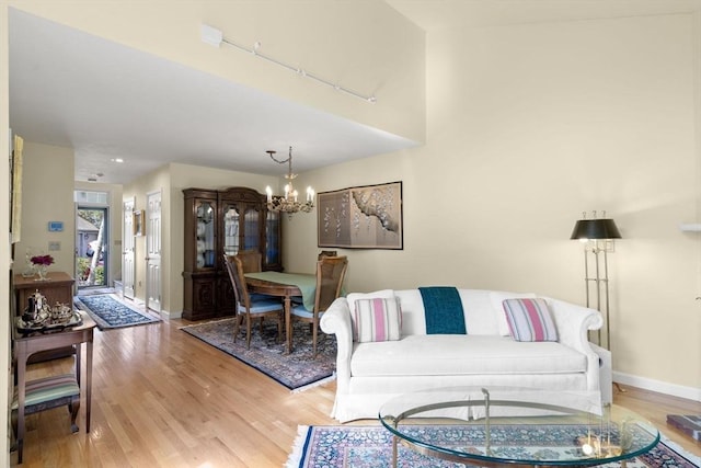27 Quarryridge Ln Unit 27, Rockport, MA 01966 - living room featuring a chandelier, light wood finished floors, and rail lighting