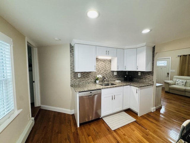 16 3rd St, Framingham, MA 01702 - kitchen featuring stainless steel dishwasher, a baseboard heating unit, dark wood finished floors, decorative backsplash, and white cabinetry