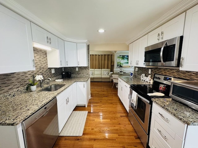 16 3rd St, Framingham, MA 01702 - kitchen featuring stainless steel appliances, backsplash, white cabinetry, and recessed lighting
