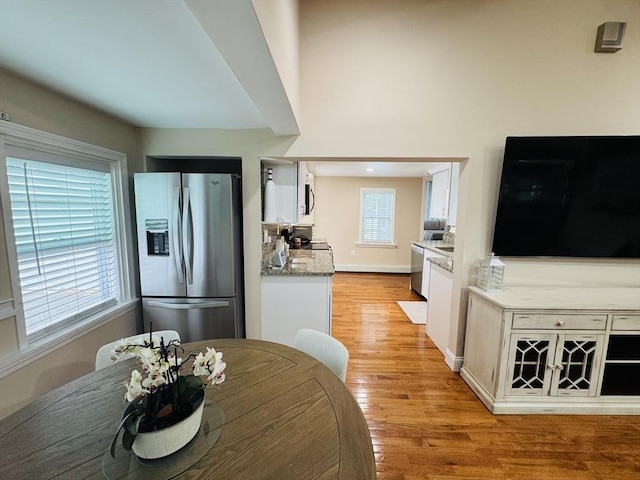 16 3rd St, Framingham, MA 01702 - kitchen featuring appliances with stainless steel finishes, white cabinets, and light wood-style floors