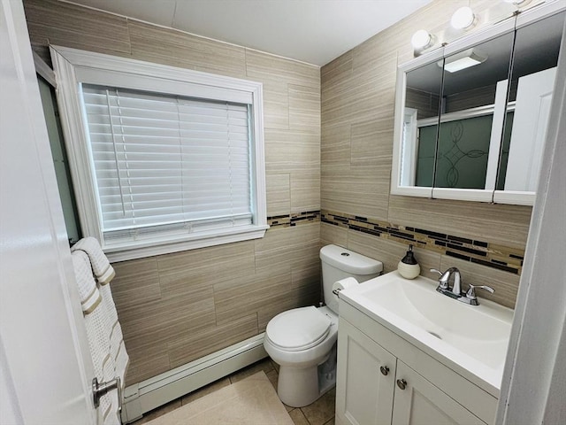 16 3rd St, Framingham, MA 01702 - bathroom with a baseboard radiator, tile walls, vanity, a shower stall, and tile patterned flooring