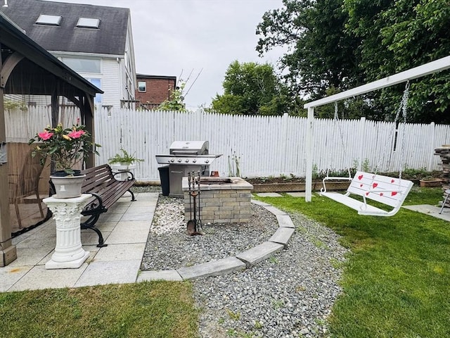 16 3rd St, Framingham, MA 01702 - fenced backyard featuring a grill and a patio area