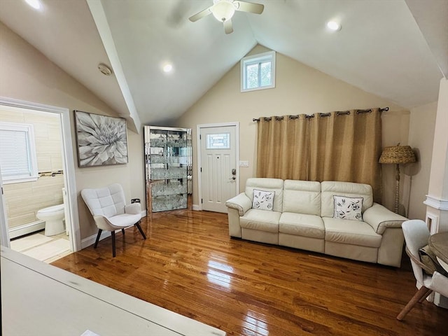 16 3rd St, Framingham, MA 01702 - living room featuring baseboard heating, vaulted ceiling, a ceiling fan, and wood-type flooring