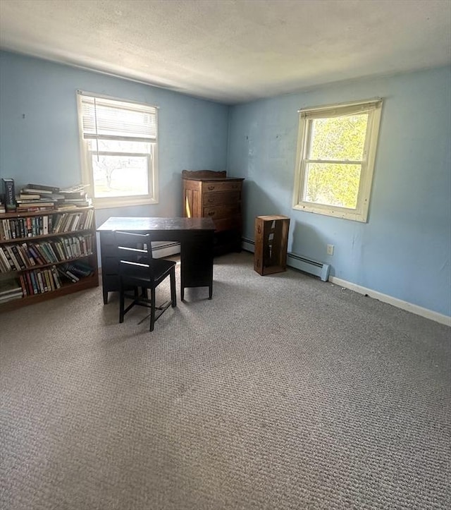 carpeted home office featuring a baseboard heating unit