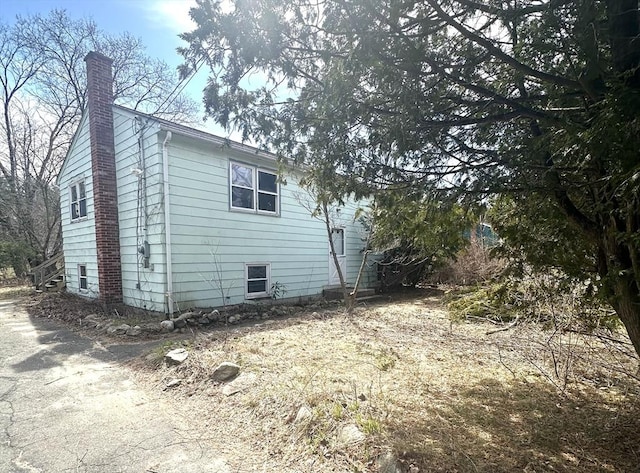 view of side of home featuring a chimney
