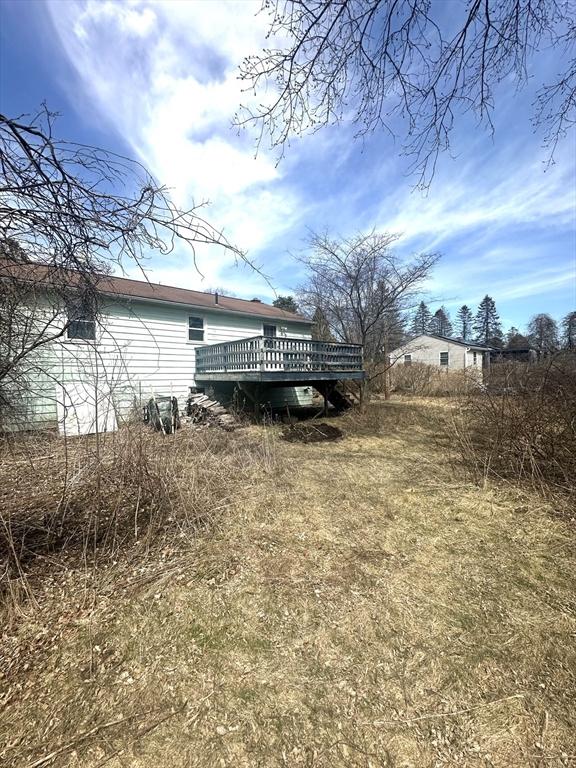 view of yard with a wooden deck
