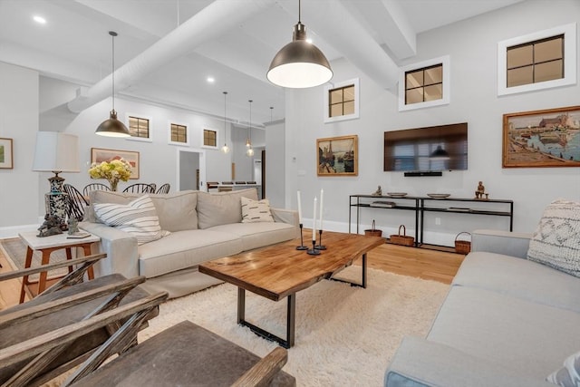 living room featuring light wood finished floors, beamed ceiling, recessed lighting, and baseboards