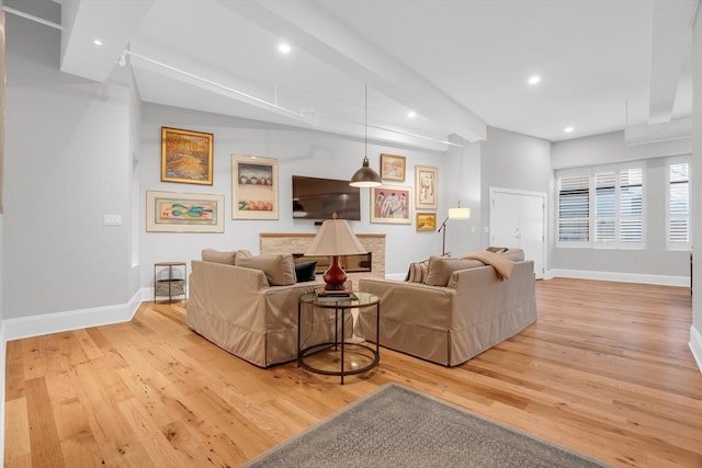 living room featuring light wood-type flooring, baseboards, and recessed lighting