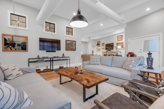 living room featuring visible vents, baseboards, wood finished floors, and recessed lighting