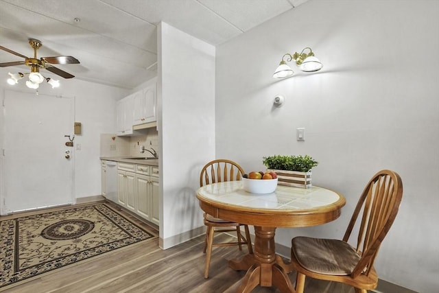 dining room with ceiling fan, baseboards, and wood finished floors