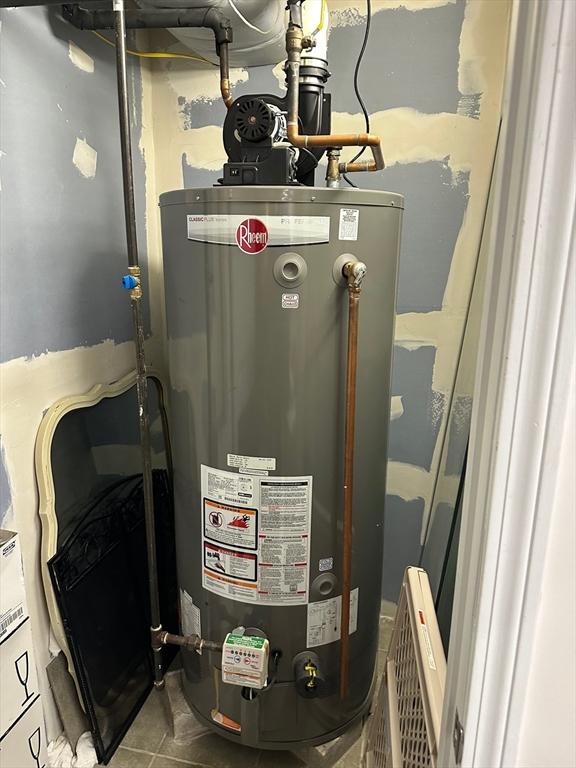 utility room featuring water heater