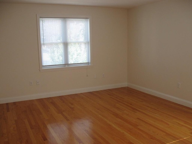 unfurnished room featuring light wood-type flooring and baseboards