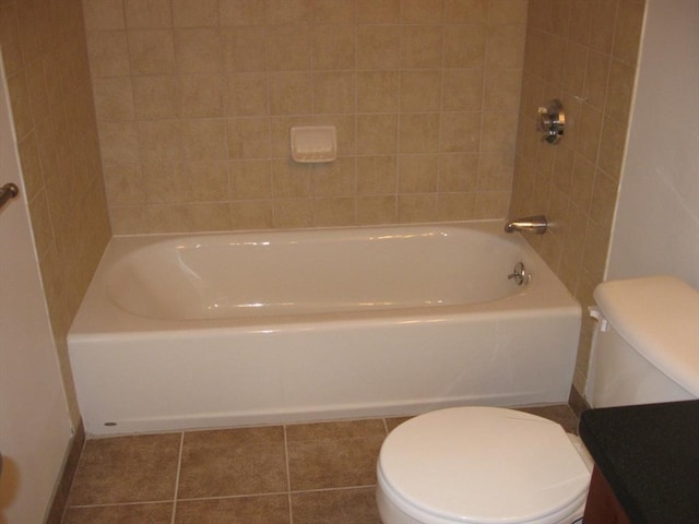 full bath featuring toilet, tile patterned flooring, and baseboards