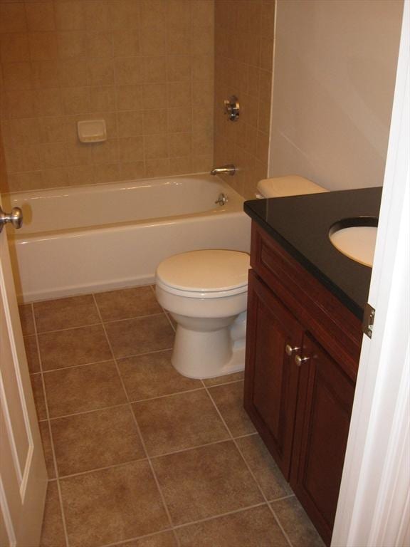 bathroom with toilet, tile patterned flooring, tub / shower combination, and vanity