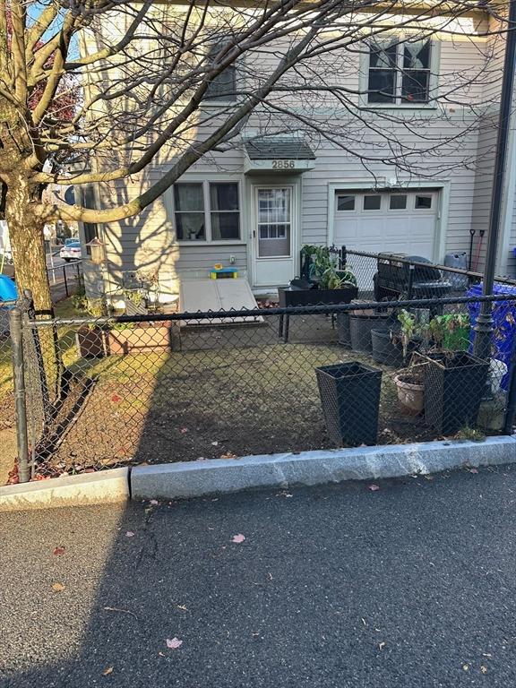 view of front of house with a fenced front yard and an attached garage