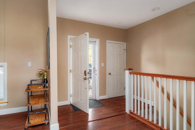 entryway with baseboards and wood finished floors