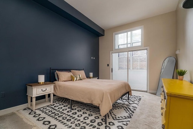 bedroom with access to exterior, baseboards, and light colored carpet