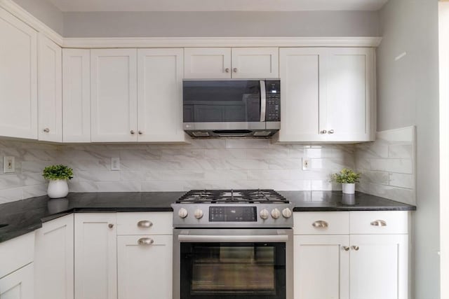 kitchen featuring appliances with stainless steel finishes, white cabinetry, and decorative backsplash