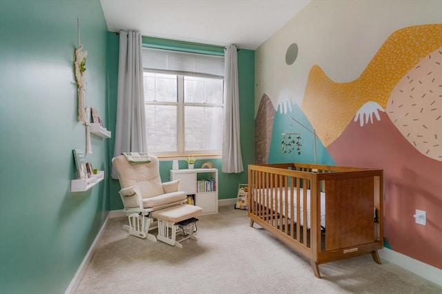 carpeted bedroom featuring a crib and baseboards