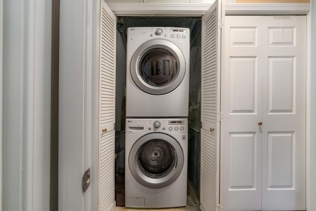 washroom featuring stacked washing maching and dryer and laundry area