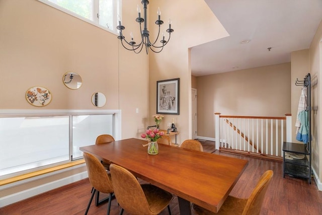 dining room featuring baseboards, a chandelier, and wood finished floors