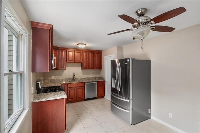 88 Cocasset St Unit 1, Foxboro, MA 02035 - kitchen with appliances with stainless steel finishes, ceiling fan, light tile patterned flooring, a sink, and light stone counters