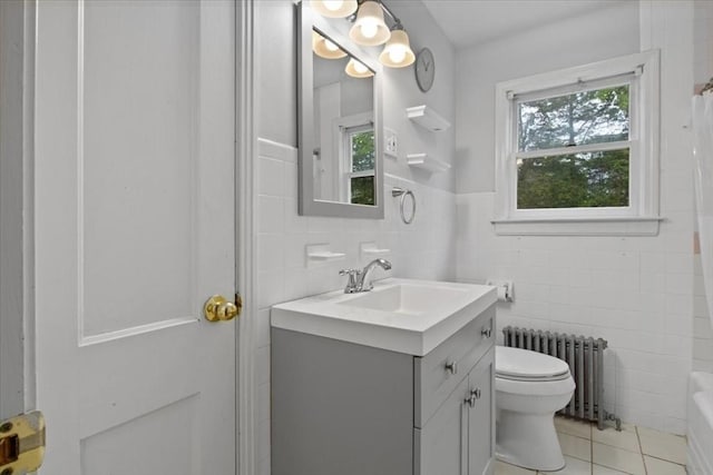 88 Cocasset St Unit 1, Foxboro, MA 02035 - bathroom with radiator heating unit, tile walls, toilet, tile patterned flooring, and vanity